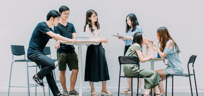 two men and four women meeting in office