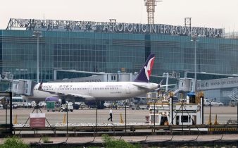 white and blue airplane on airport during daytime