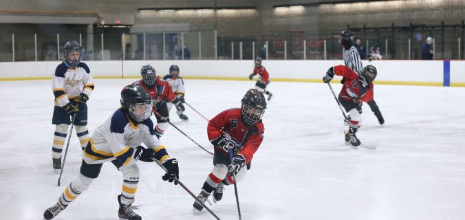 men playing ice hockey on ice stadium